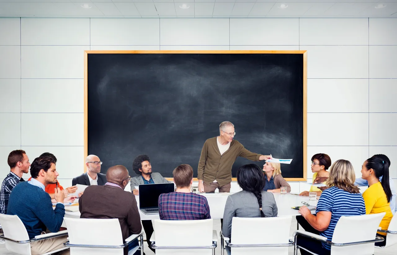 Instructor leading adult education classroom discussion