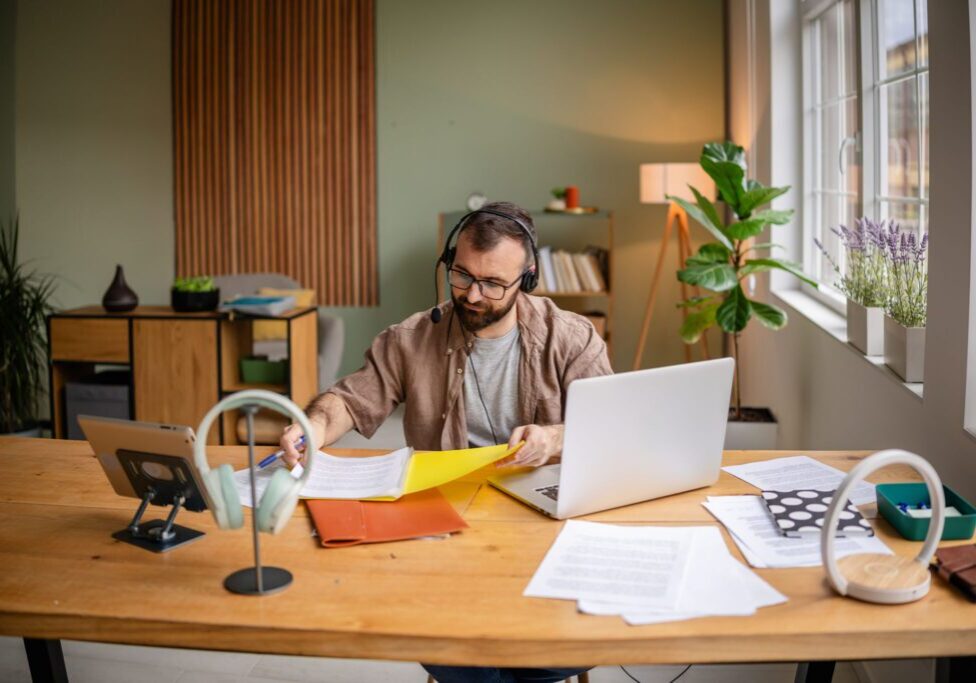 Man working at desk with laptop.